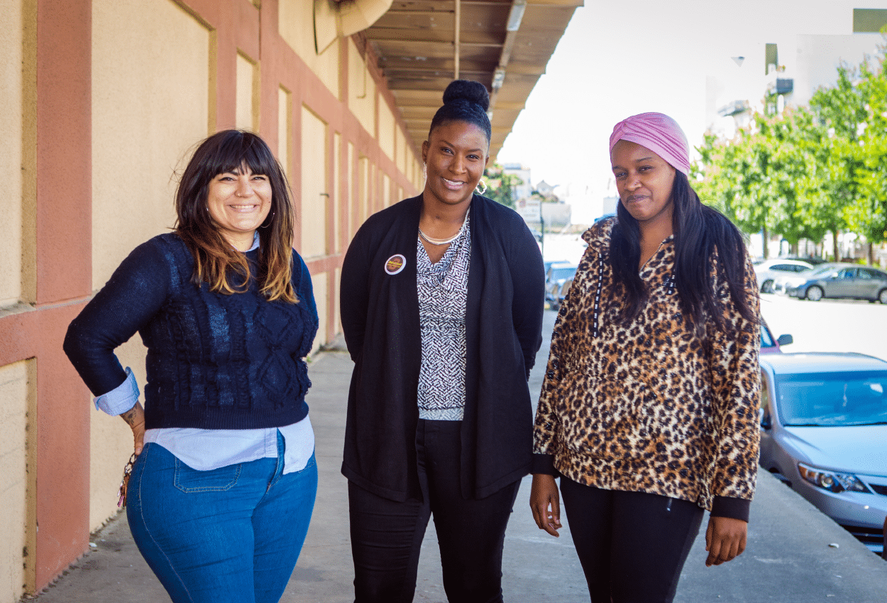 Three women standing together outside